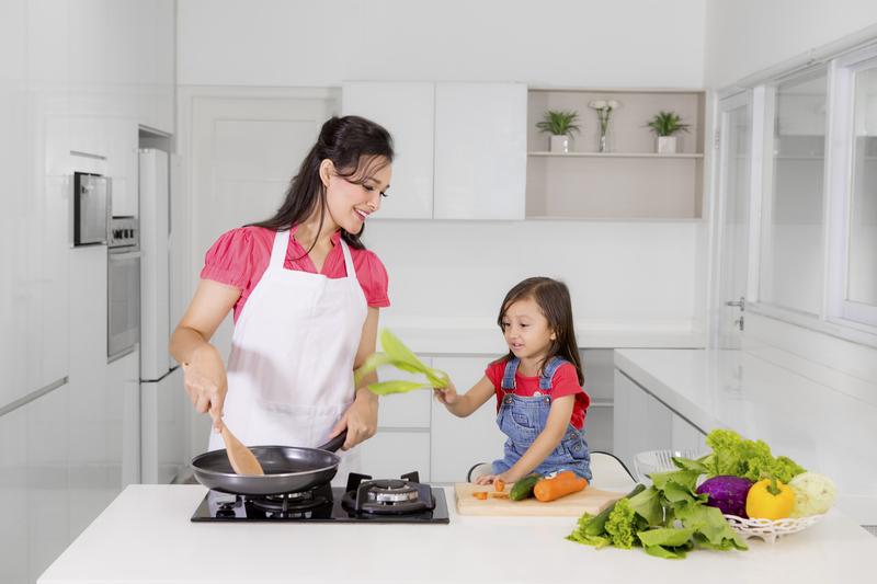 Mother and Child Cooking in Kitchen with Vegetables